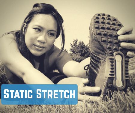 image-of-a-woman-sitting-on-the-ground-stretching-her-left-hamstring-